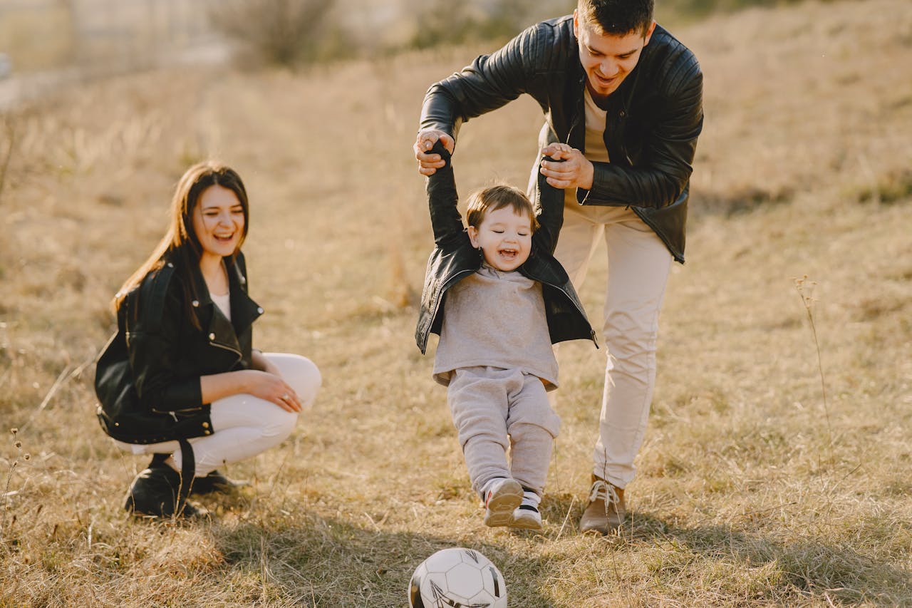 The Art of Drawing Readers In: Your attractive post title goes here Family enjoying playful soccer game outdoors, capturing joyful moments.