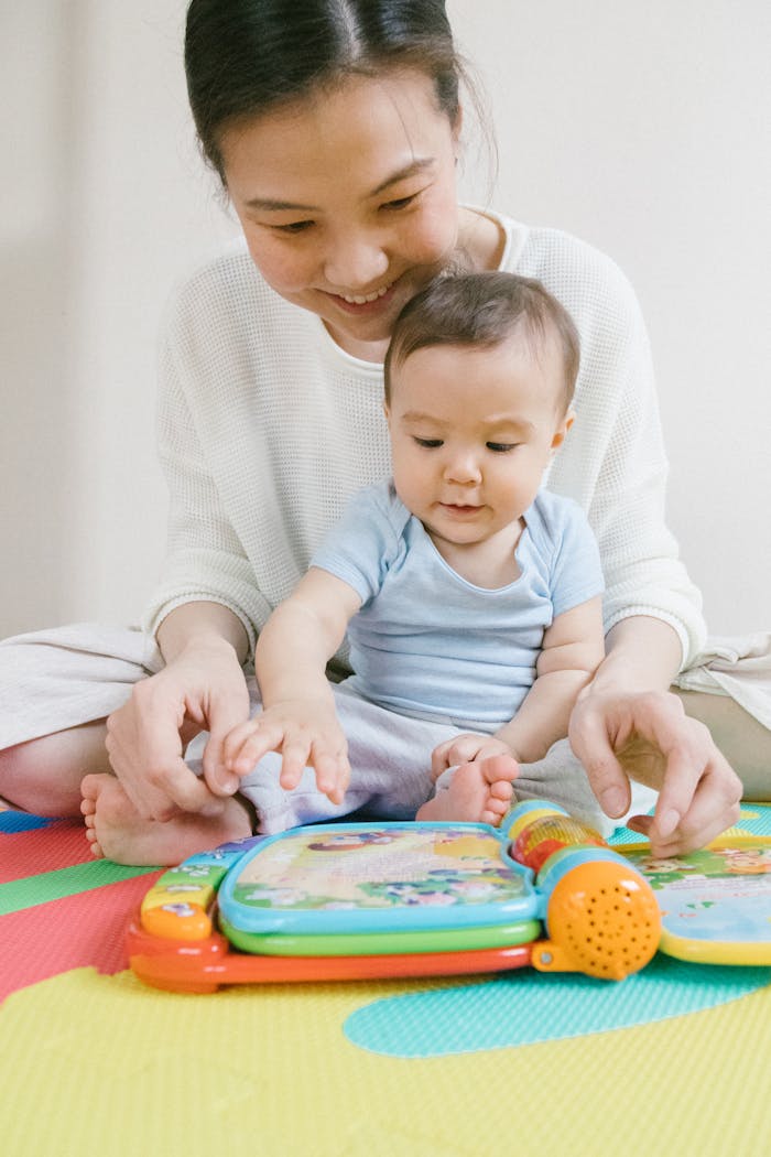 services-01 A happy mother and baby enjoy playtime with a colorful educational toy, fostering learning.