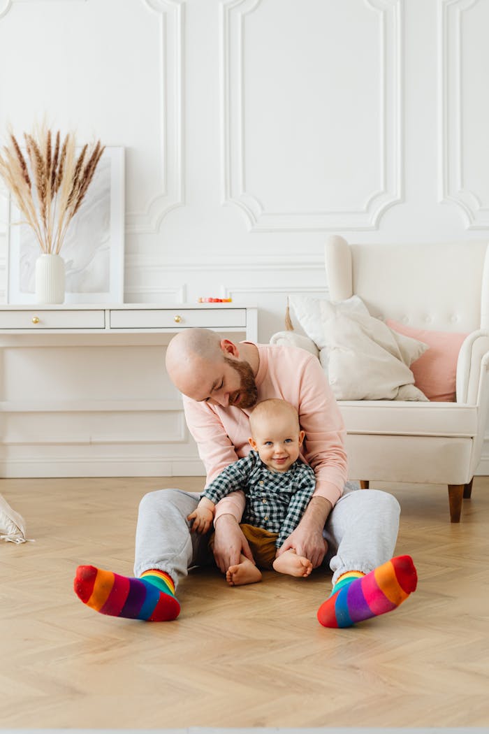 Mastering the First Impression: Your intriguing post title goes here A loving father cuddling his cheerful baby in a cozy living room.
